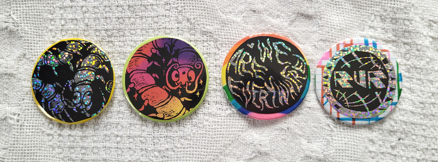 Four buttons made with scratch-art