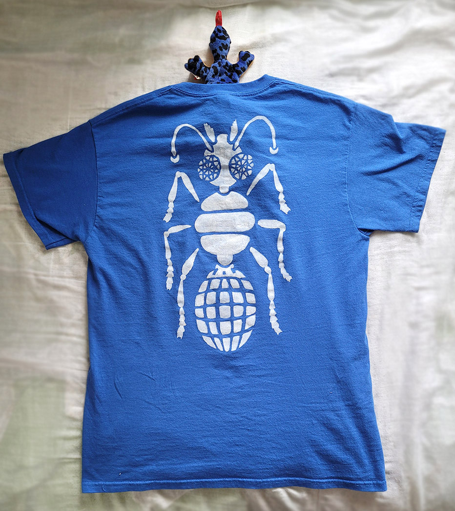 A blue shirt with a white robotic ant along the back