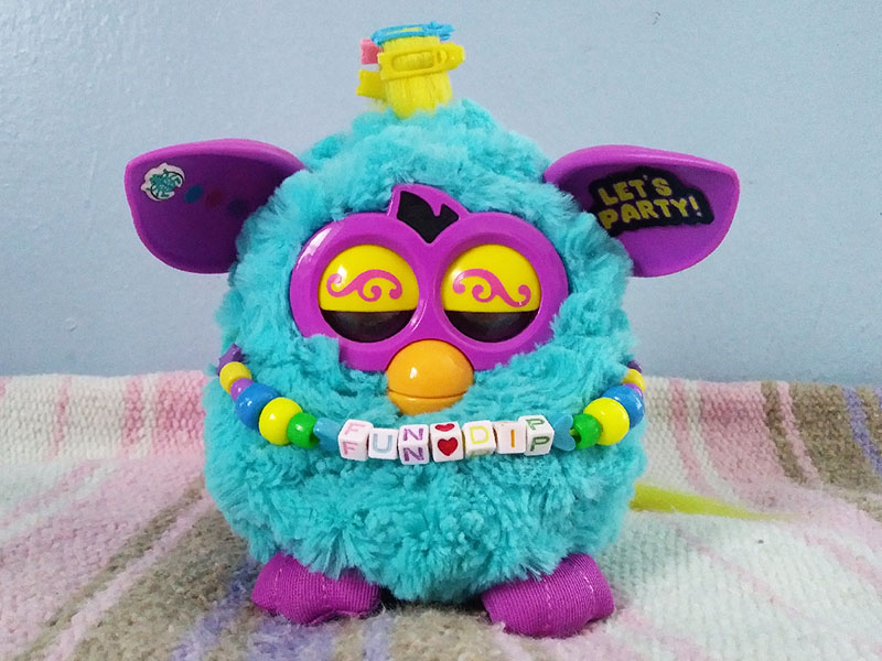 A sleeping blue and purple Furby