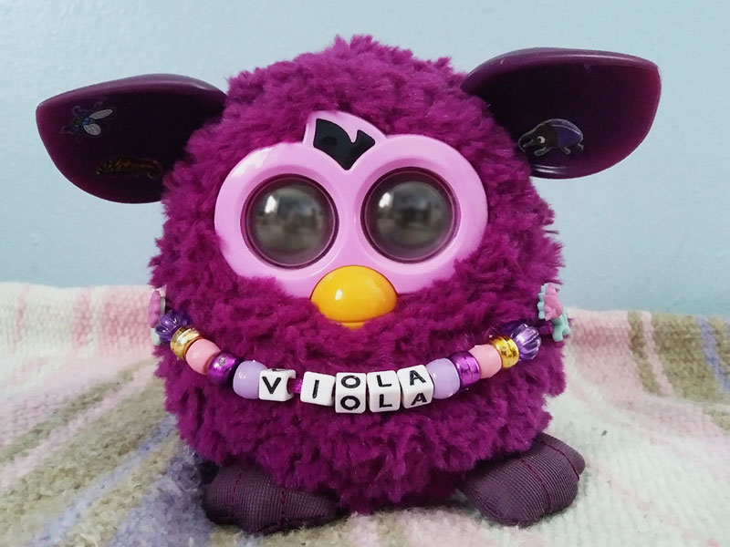 A sleeping purple Furby